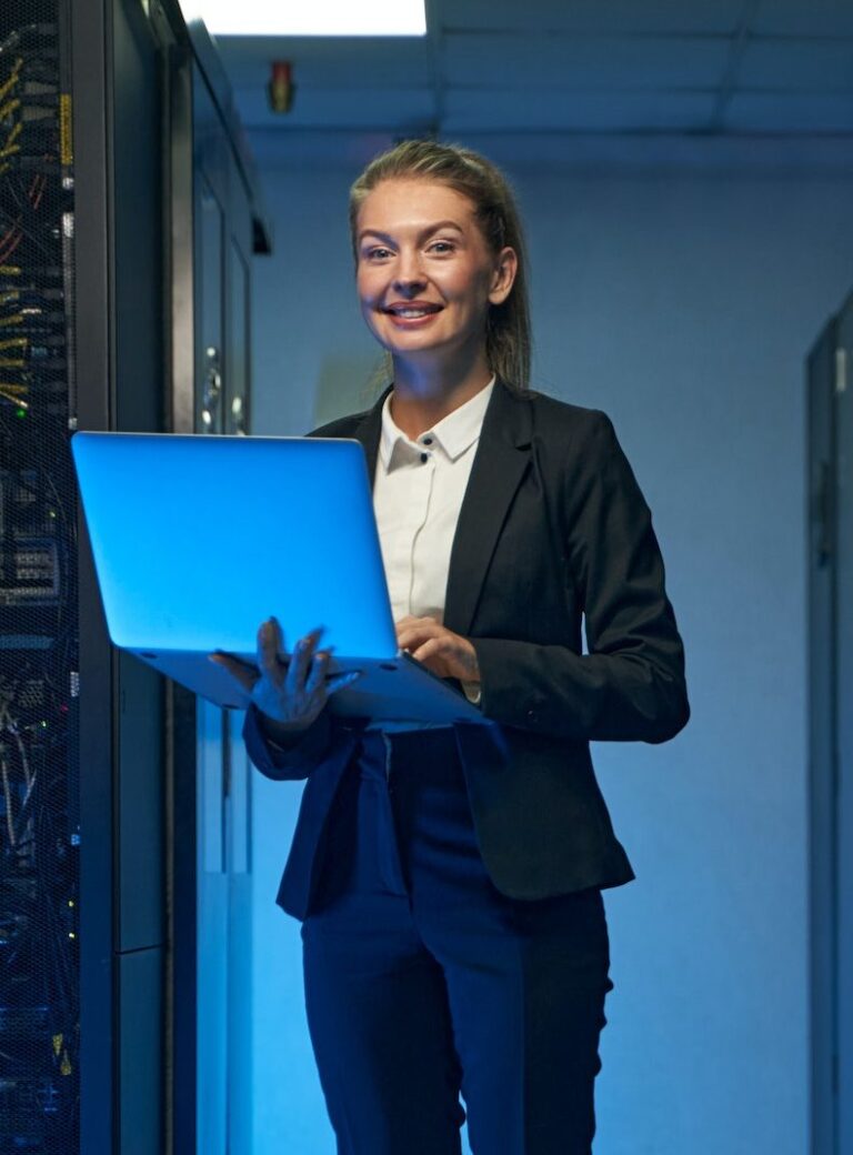 smiling-system-administrator-working-on-cyber-security-in-data-center-e1688365286776